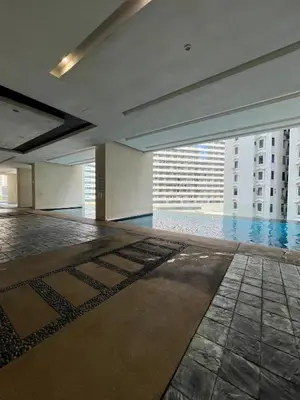 an empty room with a swimming pool in a building at Great Value 2-Bedroom KLCC Unit in Kuala Lumpur