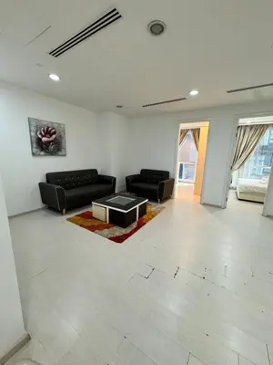 a living room with two black couches and a coffee table at Great Value City Center Unit in Kuala Lumpur