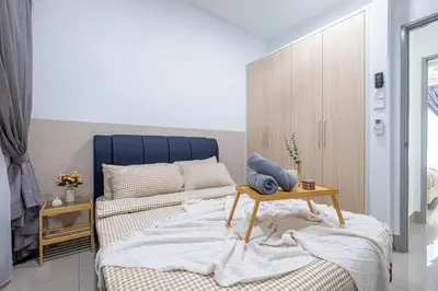 a bedroom with a bed with a table on it at RC Residence By Feel Home in Kuala Lumpur