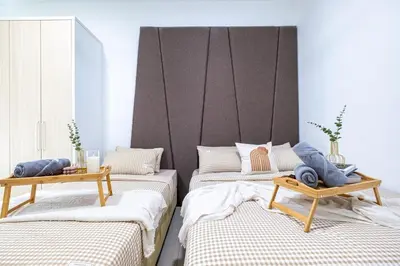 a room with three beds and two tables at RC Residence By Feel Home in Kuala Lumpur