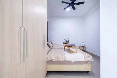 a bedroom with a bed and a refrigerator at RC Residence By Feel Home in Kuala Lumpur