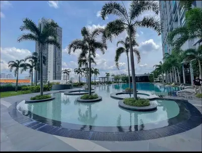 a pool with palm trees in a resort at trion kl one bedroom studio in Kuala Lumpur