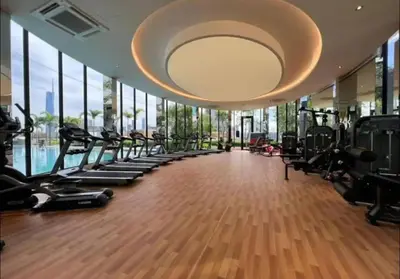 a gym with a row of treadmills and ellipticals at trion kl one bedroom studio in Kuala Lumpur