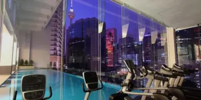 a gym with a view of a city skyline at 1Bukit ceylon view 118 in Kuala Lumpur