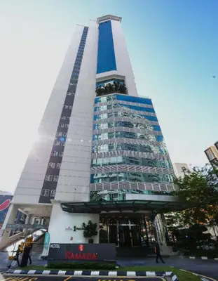 a tall building with a sign in front of it at 1Bukit ceylon view 118 in Kuala Lumpur