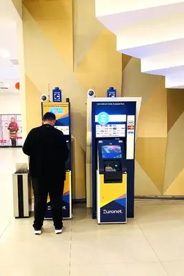 a man standing in front of a atm machine at Mercu Summer Suites near KLCC in Kuala Lumpur