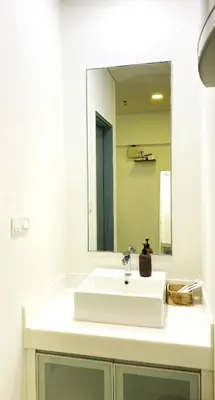 a bathroom with a white sink and a mirror at Mercu Summer Suites near KLCC in Kuala Lumpur