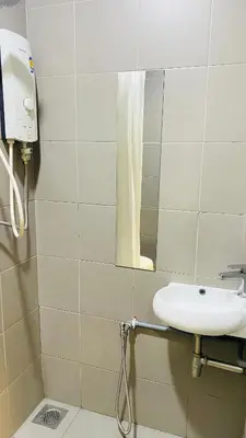 a bathroom with a sink and a mirror at Mercu Summer Suites near KLCC in Kuala Lumpur
