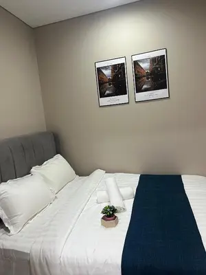 a bedroom with a bed with three pictures on the wall at Vortex Suites KLCC, 10 Pax - 3 Bedrooms Apartment in Kuala Lumpur