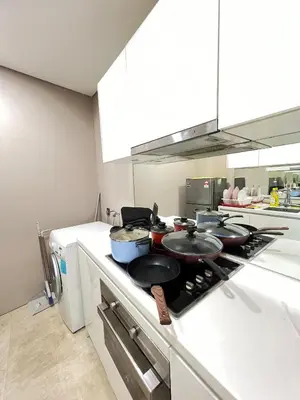 a kitchen with a stove with pots and pans on it at Vortex Suites KLCC, 10 Pax - 3 Bedrooms Apartment in Kuala Lumpur