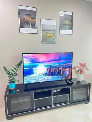 a flat screen tv sitting on top of a entertainment center at Vortex Suites KLCC, 10 Pax - 3 Bedrooms Apartment in Kuala Lumpur