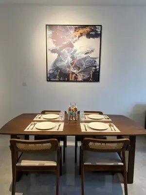a dining room table with chairs and a painting on the wall at AGILE Galaxy Suite in Kuala Lumpur