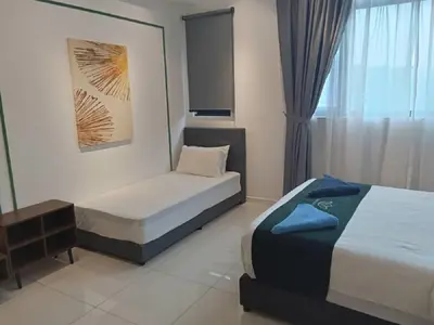 a hotel room with two beds and a window at Starlight Suite At Chambers Kuala Lumpur KLCC in Kuala Lumpur