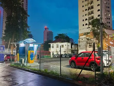 a red car parked at a gas station in a city at Starlight Suite At Chambers Kuala Lumpur KLCC in Kuala Lumpur