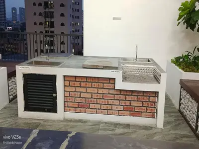 an outdoor kitchen with a sink on a balcony at Starlight Suite At Chambers Kuala Lumpur KLCC in Kuala Lumpur