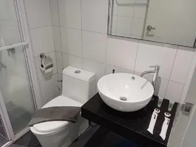 a bathroom with a white toilet and a sink at Starlight Suite At Chambers Kuala Lumpur KLCC in Kuala Lumpur