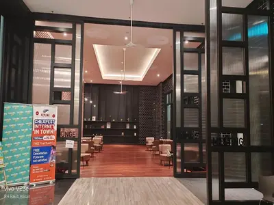 a lobby with a waiting room with tables and chairs at Starlight Suite At Chambers Kuala Lumpur KLCC in Kuala Lumpur
