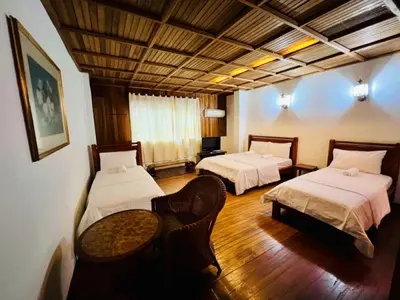 a room with two beds and a table in it at Iviillainn in Kuala Lumpur