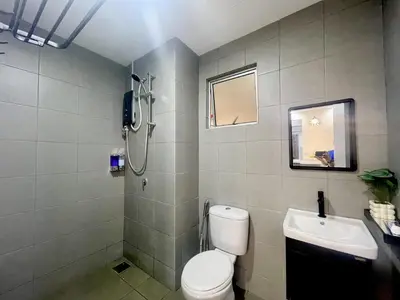 a bathroom with a shower and a toilet and a sink at Homestay Inspirasi in Kuala Lumpur