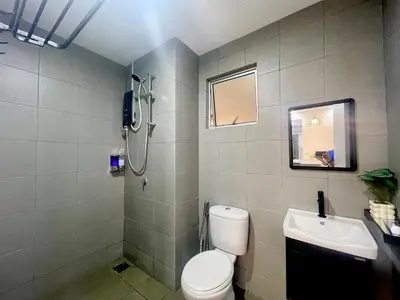 a bathroom with a shower and a toilet and a sink at Homestay Inspirasi in Kuala Lumpur