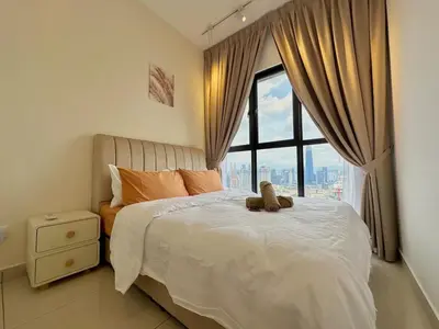 a bed with a teddy bear on it in a bedroom at 9 Pax 3R3B Trion KL City View 10Mins to KLCC in Kuala Lumpur