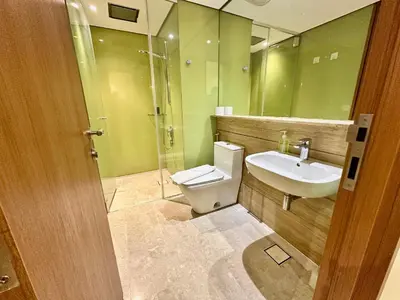 a bathroom with a toilet and a sink and a mirror at Sky Premium suites klcc in Kuala Lumpur