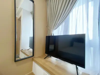 a flat screen tv sitting in front of a mirror at The colony by Klcc view sweet home in Kuala Lumpur