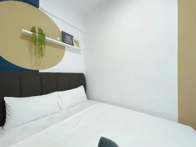 a bedroom with a bed with a cactus on a shelf at The colony by Klcc view sweet home in Kuala Lumpur