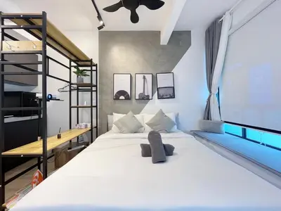 a bedroom with a large white bed and a ladder at The colony by Klcc view sweet home in Kuala Lumpur