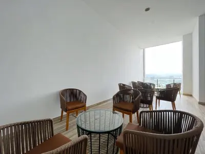 a group of chairs and tables in a room at The colony by Klcc view sweet home in Kuala Lumpur