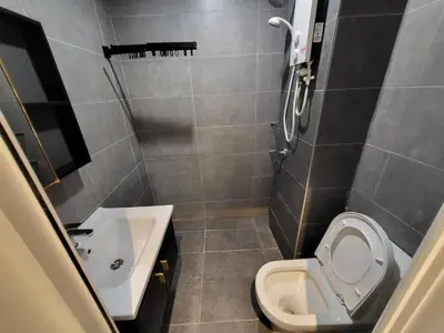 a small bathroom with a toilet and a sink at Mini studio Neu suites KLCC in Kuala Lumpur
