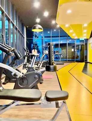 a gym with several treadmills and cardio machines at Private Room Queen Size KLCC in Kuala Lumpur