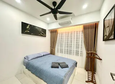 a bedroom with a bed and a ceiling fan at Homestay Inspirasi in Kuala Lumpur