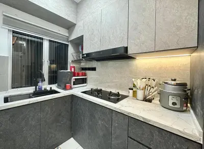 a kitchen with a sink and a stove top oven at Homestay Inspirasi in Kuala Lumpur