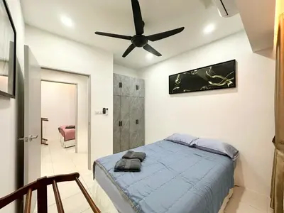 a bedroom with a bed and a ceiling fan at Homestay Inspirasi in Kuala Lumpur