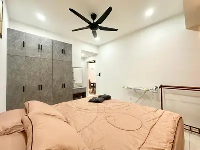 a bedroom with a bed with a ceiling fan at Homestay Inspirasi in Kuala Lumpur