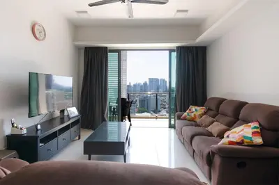 a living room with a couch and a flat screen tv at Chic High-Floor 3BR Apt in Bukit Bintang in Kuala Lumpur