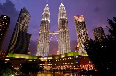 a group of tall skyscrapers in a city at night at Chic High-Floor 3BR Apt in Bukit Bintang in Kuala Lumpur