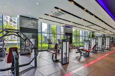 a gym with treadmills and chairs in a building at Star Deluxe Suites KLCC by WSD in Kuala Lumpur