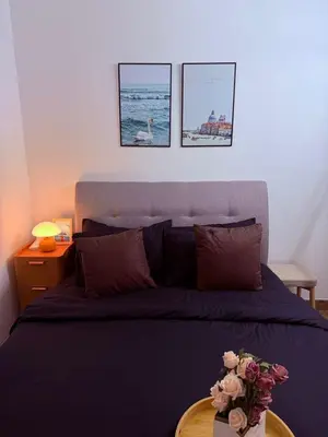 a bedroom with a bed and a table with flowers on it at Sentrio Pandan Kuala Lumpur KLCC KL Tower TRX 10 in Kuala Lumpur