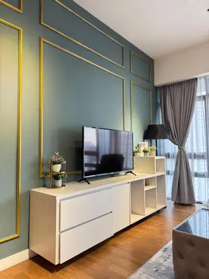 a living room with a television on a entertainment center at XING LUN KLCC Anggun residents in Kuala Lumpur