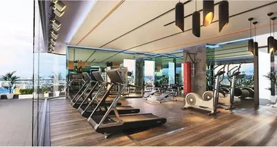 a gym with several treadmills and elliptical machines at The Robertson Residence Kuala Lumpur with City views in Kuala Lumpur