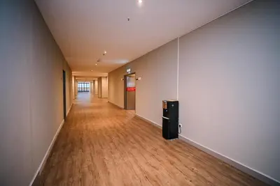 an empty hallway in an office with a hard wood floor at Kingston Hotel 12 - Jalan Raja Laut, KL in Kuala Lumpur