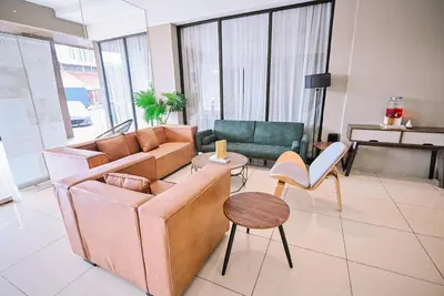 a living room with a couch and chairs at Kingston Hotel 12 - Jalan Raja Laut, KL in Kuala Lumpur