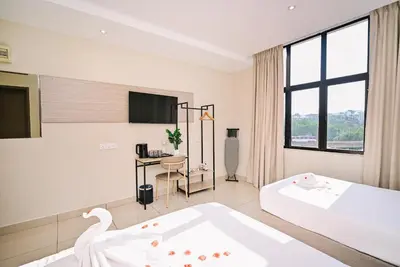 a white room with a bed and a desk at Kingston Hotel 12 - Jalan Raja Laut, KL in Kuala Lumpur