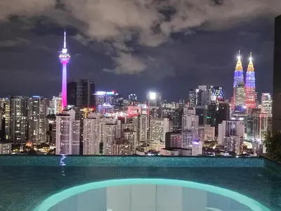 a view of a city skyline at night at Lucentia Residences in Kuala Lumpur