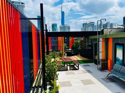 a balcony with a colorful fence and a picnic table at EASSY Hotel KL Sentral in Kuala Lumpur