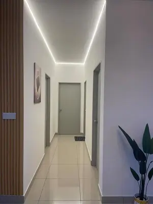 a hallway with white walls and a white hallway at RumaDuke Kuala Lumpur with Netflix and KLCC Views in Kuala Lumpur