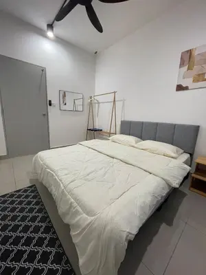 a bedroom with a large bed with a ceiling fan at RumaDuke Kuala Lumpur with Netflix and KLCC Views in Kuala Lumpur