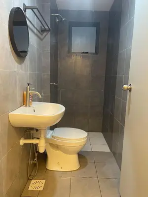 a bathroom with a toilet and a sink at RumaDuke Kuala Lumpur with Netflix and KLCC Views in Kuala Lumpur